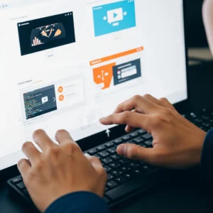 Close-up of a person's hands expertly typing on a laptop, engaged in web design, a key offering of professional digital marketing services in Dubai for creating engaging online presences.